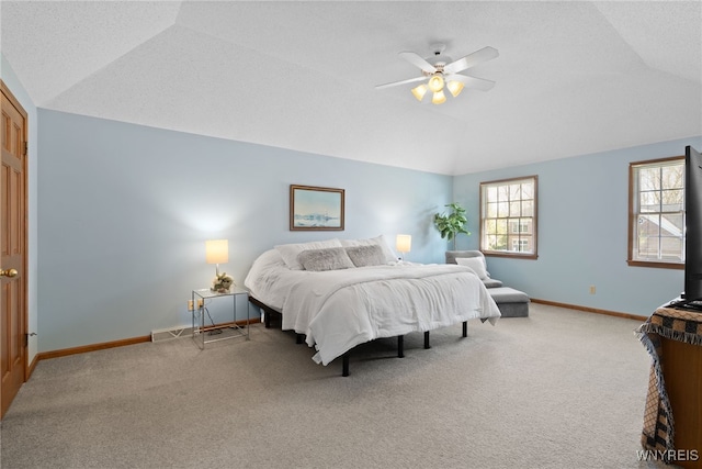 carpeted bedroom with baseboards, ceiling fan, and lofted ceiling