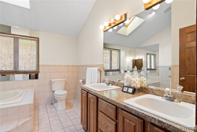 full bath featuring a sink, tile patterned floors, lofted ceiling with skylight, and visible vents