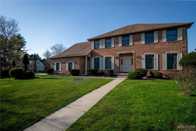colonial house with brick siding and a front yard