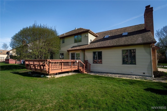 back of house featuring a lawn, a deck, a chimney, and roof with shingles