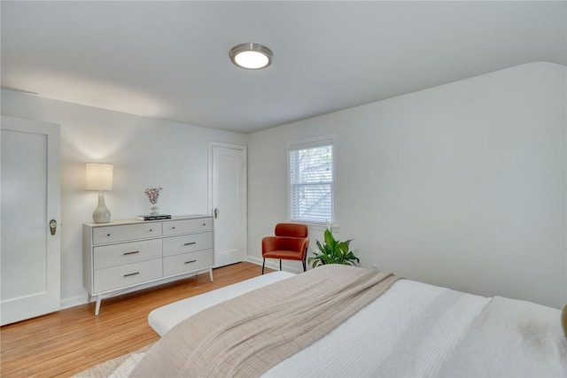 bedroom with baseboards and light wood-style flooring