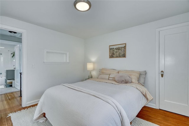 bedroom featuring baseboards and light wood-type flooring