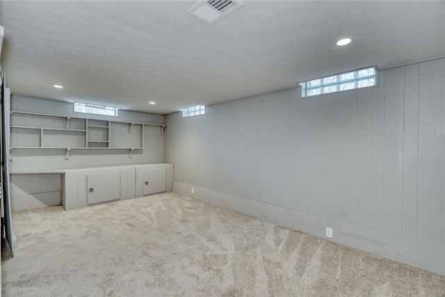 below grade area with a healthy amount of sunlight, carpet floors, recessed lighting, and visible vents