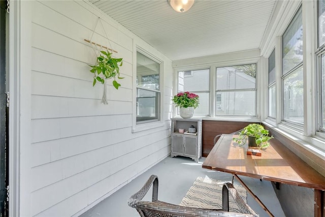 sunroom / solarium featuring concrete flooring