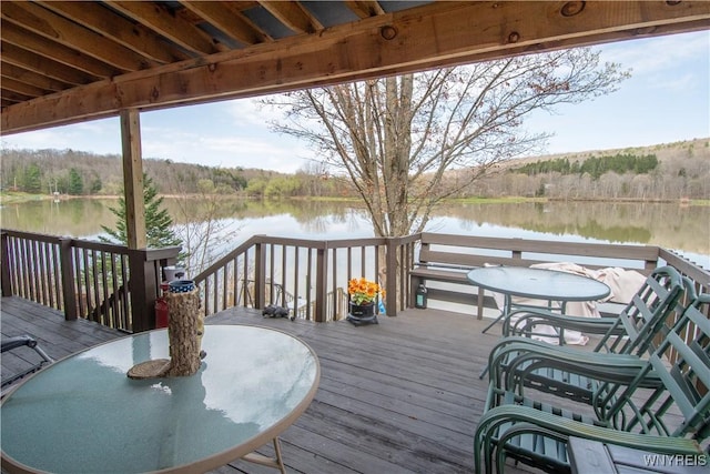 deck featuring a water view and a forest view