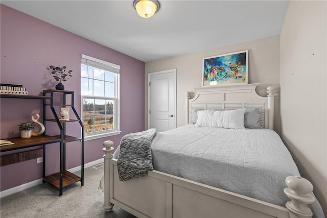 carpeted bedroom featuring baseboards