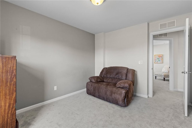 sitting room with baseboards, carpet flooring, and visible vents