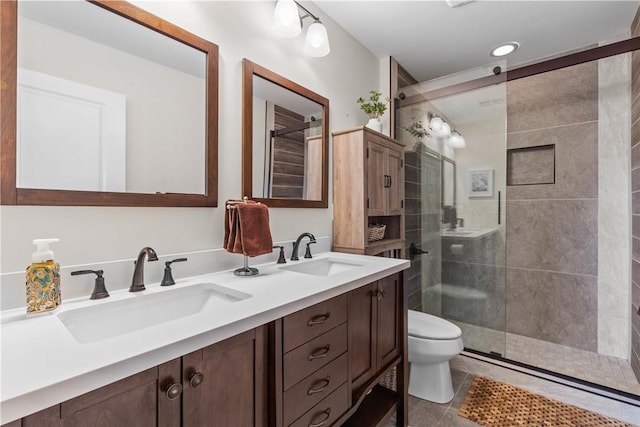 bathroom with a sink, a shower stall, and toilet