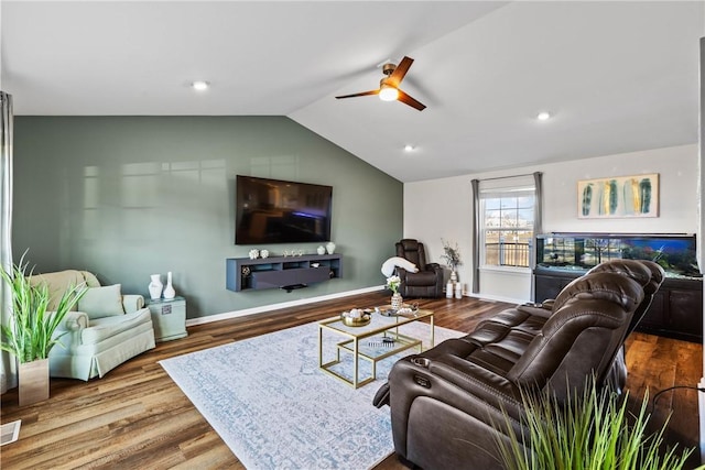 living area with a ceiling fan, baseboards, wood finished floors, and lofted ceiling