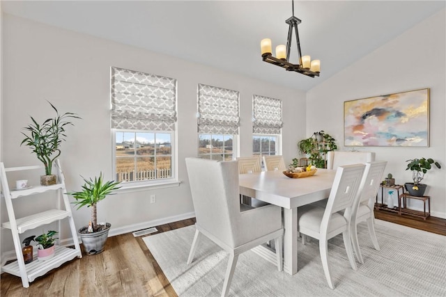 dining room featuring visible vents, wood finished floors, a notable chandelier, and a wealth of natural light