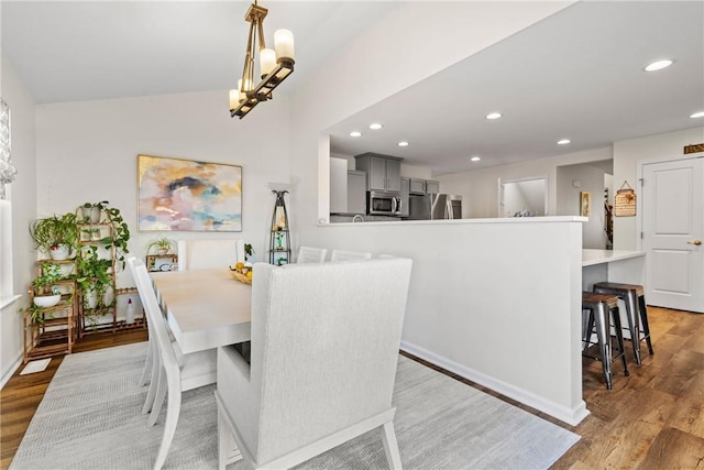 dining area with recessed lighting, baseboards, and light wood-type flooring