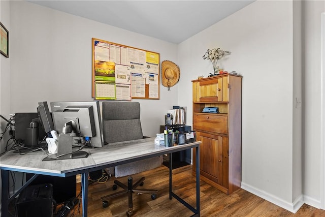 office area with baseboards and wood finished floors