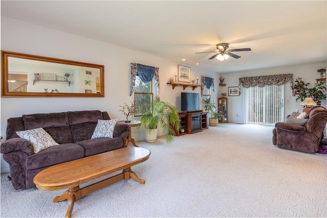 carpeted living room featuring ceiling fan