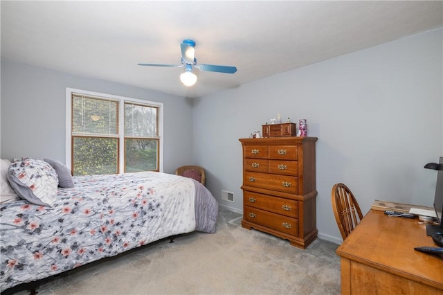 bedroom featuring visible vents, a ceiling fan, and light carpet