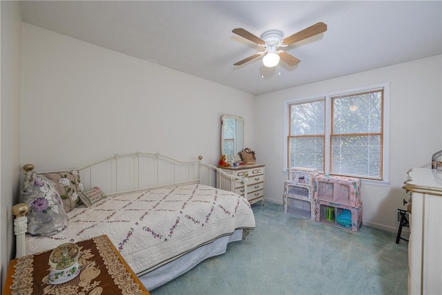 carpeted bedroom featuring baseboards and a ceiling fan