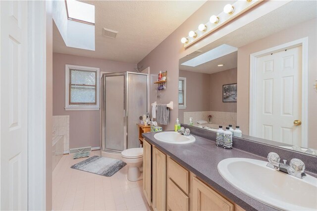 bathroom featuring toilet, a sink, a bath, and a stall shower