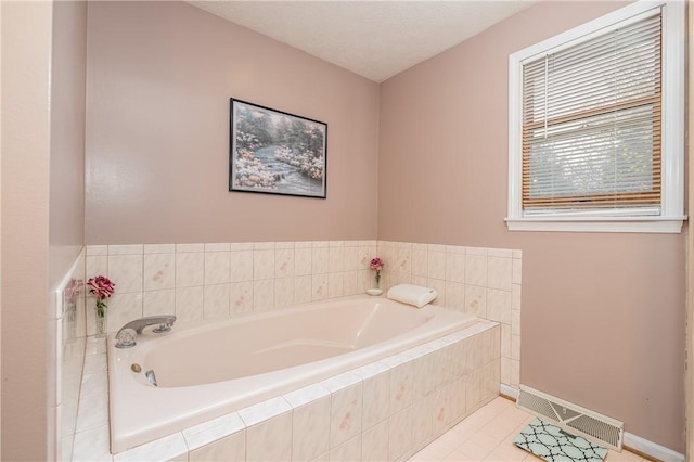 full bath with baseboards, tile patterned flooring, a bath, and visible vents