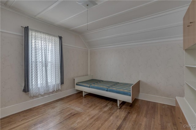 427 S James St, Wilna, NY 13619 - unfurnished bedroom with baseboards, attic access, vaulted ceiling, and hardwood / wood-style flooring