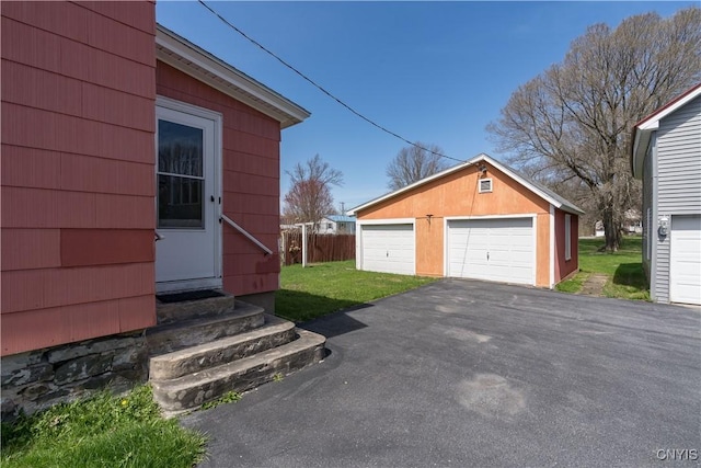 427 S James St, Wilna, NY 13619 - view of side of home featuring entry steps, a detached garage, an outdoor structure, and a lawn