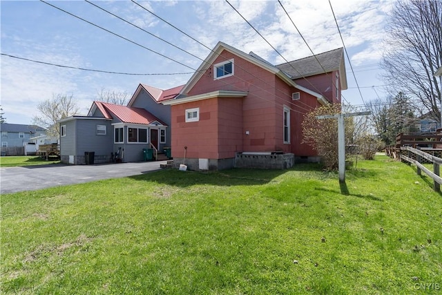 427 S James St, Wilna, NY 13619 - view of side of home featuring fence, a yard, and driveway