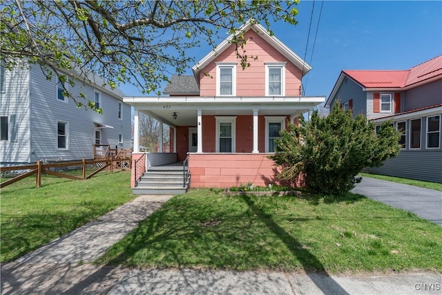 427 S James St, Wilna, NY 13619 - view of front facade featuring fence, a porch, and a front yard