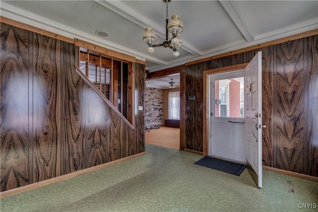 427 S James St, Wilna, NY 13619 - entrance foyer featuring wood walls, beamed ceiling, a chandelier, carpet flooring, and stairs