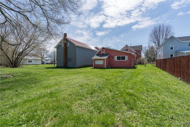 427 S James St, Wilna, NY 13619 - back of house with fence, an outdoor structure, a chimney, and a yard