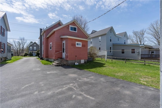 427 S James St, Wilna, NY 13619 - back of house featuring a yard, fence, driveway, and entry steps
