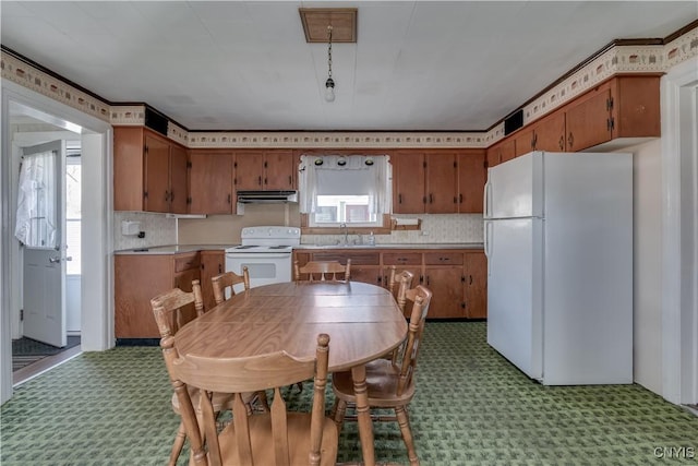 427 S James St, Wilna, NY 13619 - kitchen with light floors, brown cabinets, and white appliances