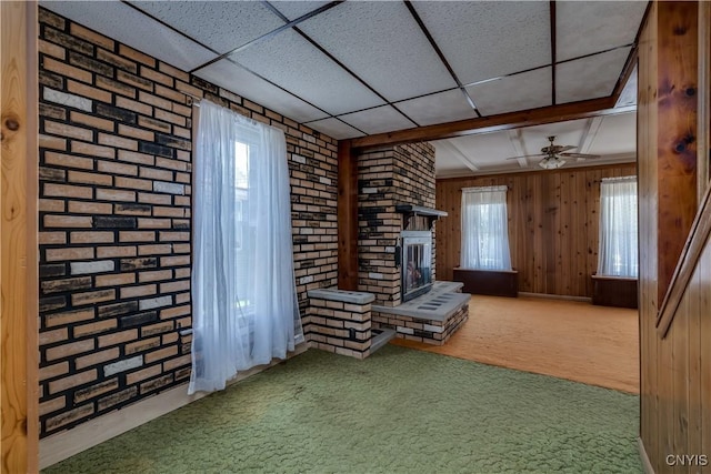 427 S James St, Wilna, NY 13619 - unfurnished room with carpet flooring, a ceiling fan, a wealth of natural light, and a fireplace