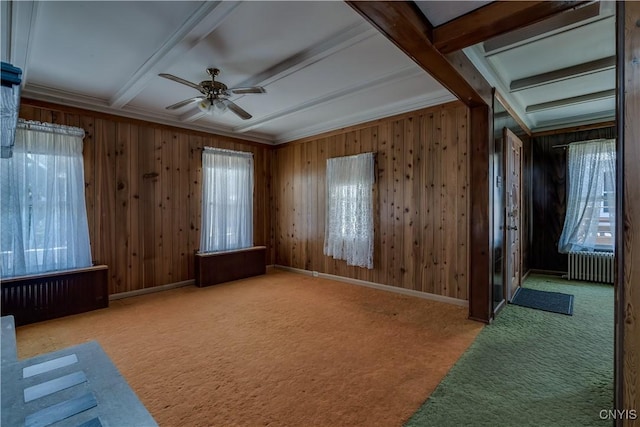 427 S James St, Wilna, NY 13619 - empty room featuring wooden walls, carpet flooring, ceiling fan, radiator heating unit, and beamed ceiling