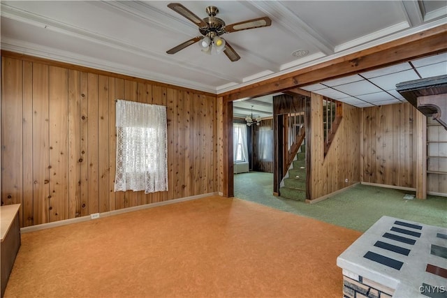 427 S James St, Wilna, NY 13619 - interior space featuring wood walls, baseboards, ceiling fan with notable chandelier, ornamental molding, and stairs