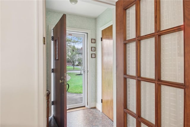 doorway to outside featuring brick floor
