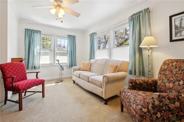interior space featuring baseboards, carpet flooring, ceiling fan, and ornamental molding
