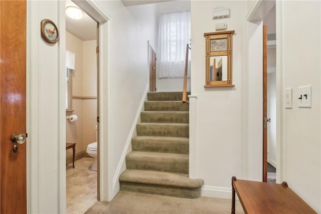 stairway featuring baseboards