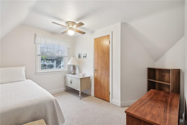 bedroom featuring a ceiling fan, baseboards, light carpet, and vaulted ceiling