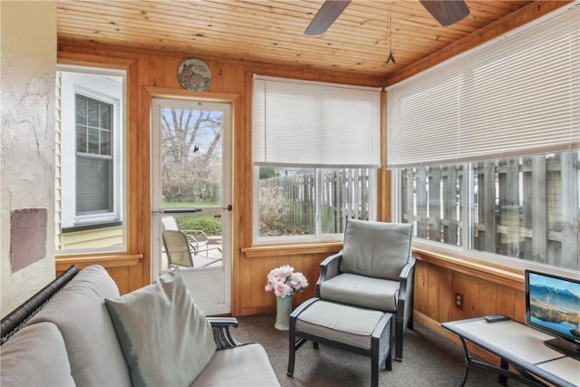 sunroom / solarium featuring wooden walls, wood ceiling, and carpet flooring