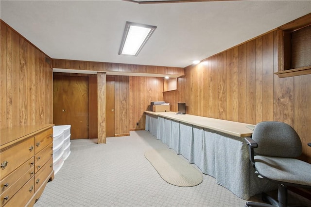 interior space with light colored carpet and wood walls