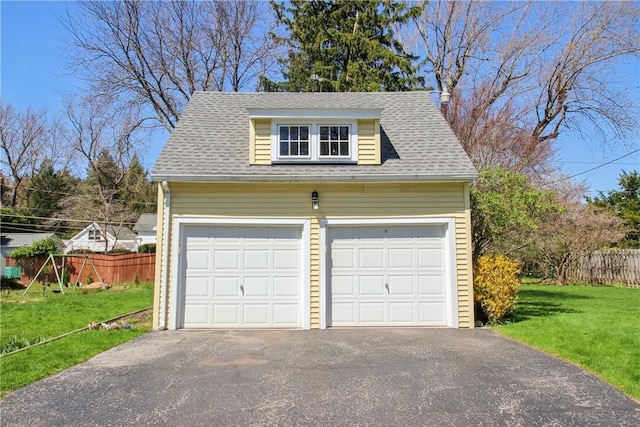detached garage featuring fence