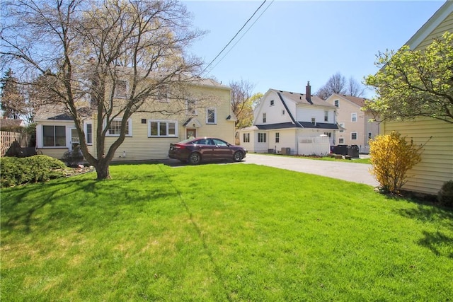 view of yard with concrete driveway