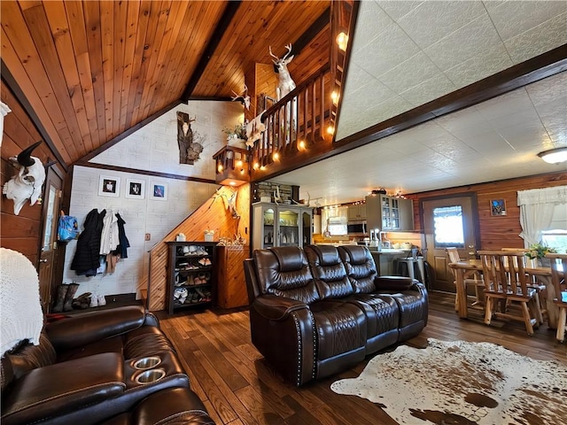 living area with wood walls, dark wood-style flooring, lofted ceiling with beams, and wood ceiling