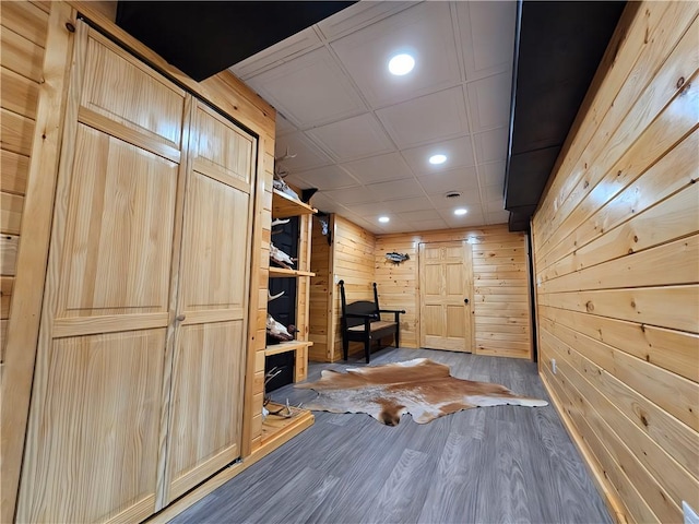interior space featuring recessed lighting, wood finished floors, and wooden walls