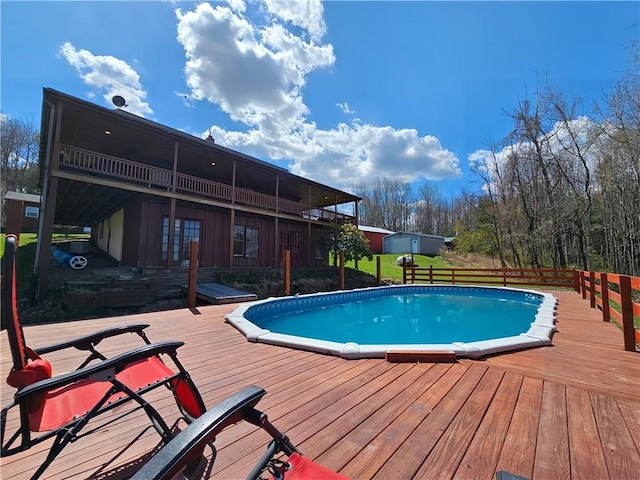 outdoor pool featuring a yard and a deck