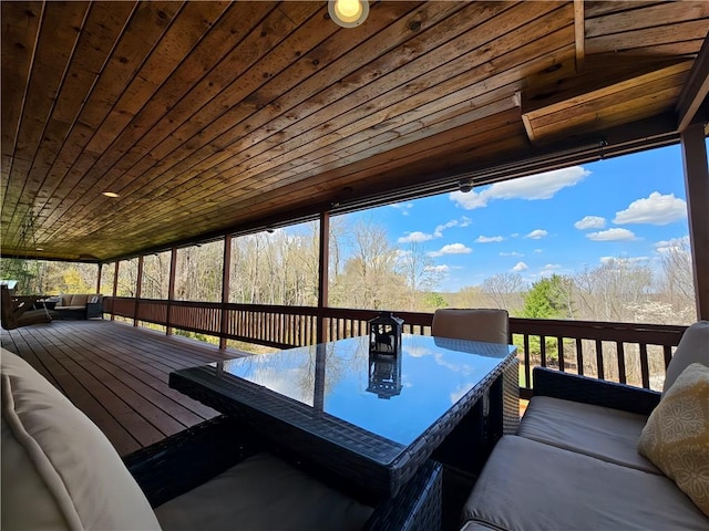 wooden terrace with outdoor dining area