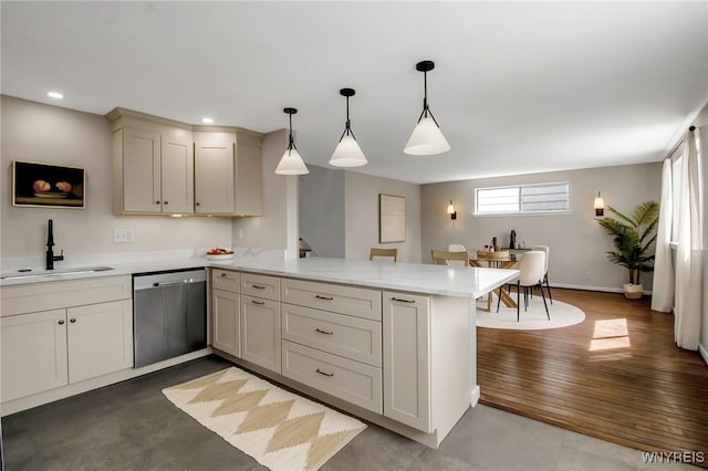 kitchen featuring stainless steel dishwasher, pendant lighting, a peninsula, recessed lighting, and a sink