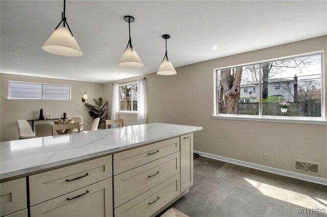 kitchen with pendant lighting, plenty of natural light, and visible vents