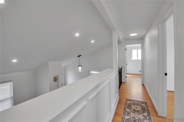 hall featuring recessed lighting, baseboards, an upstairs landing, and light wood-type flooring