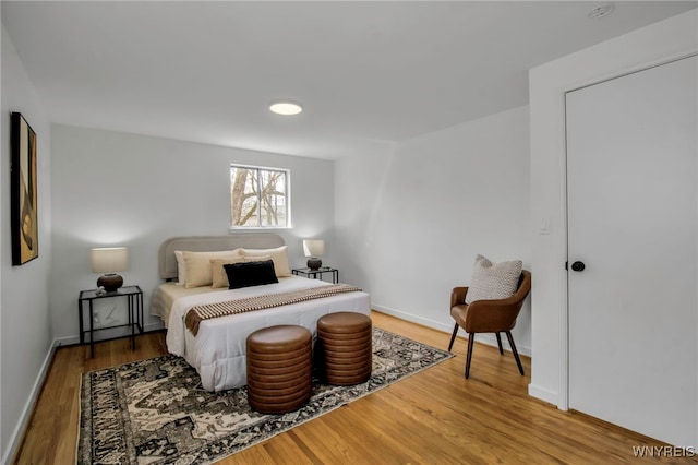bedroom with baseboards and wood finished floors