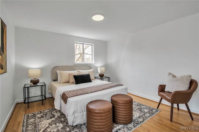 bedroom featuring baseboards and wood finished floors