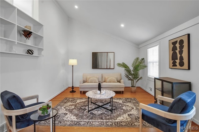 living area with wood finished floors, recessed lighting, and lofted ceiling